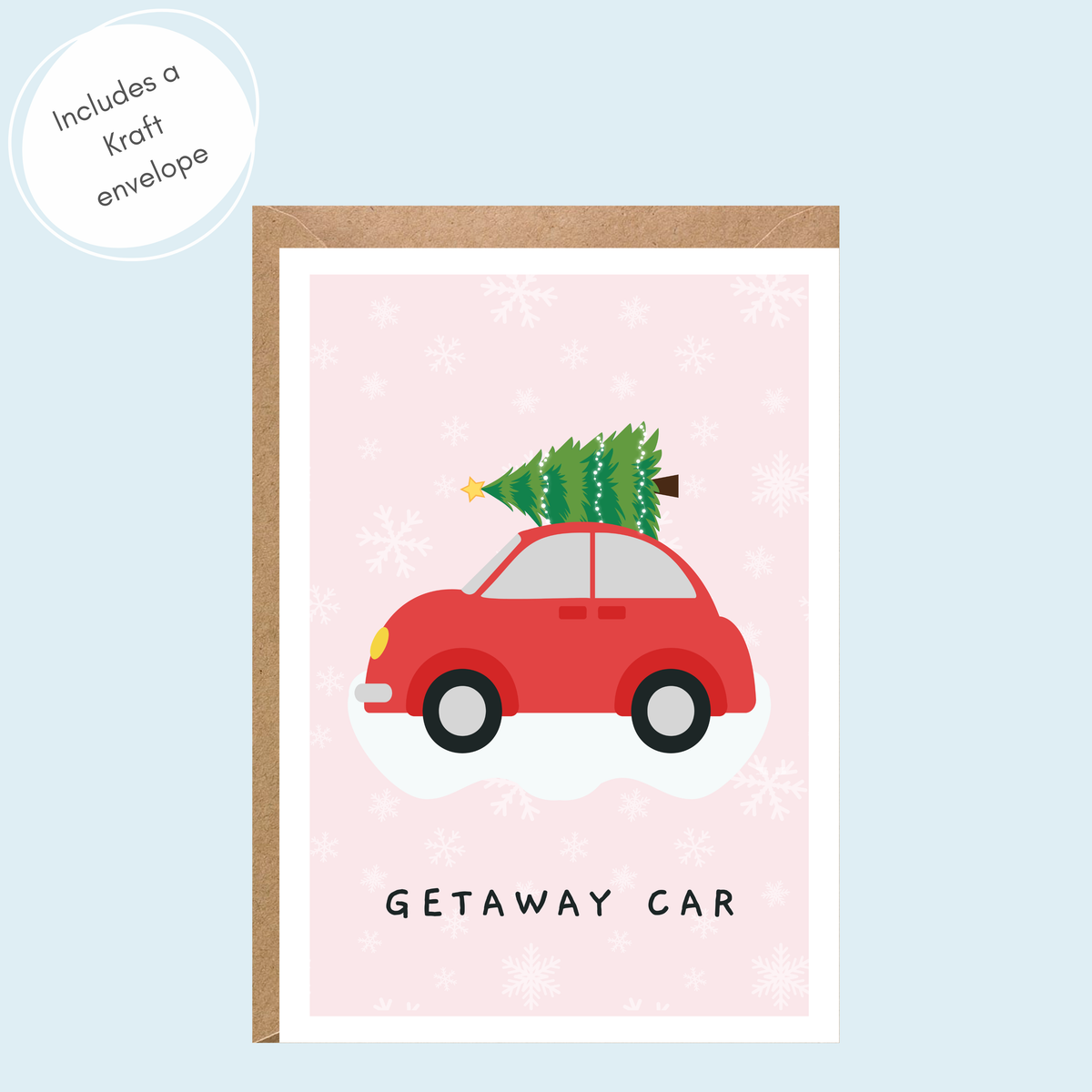 A Christmas-themed greeting card with a kraft envelope, featuring a red car carrying a green Christmas tree on a light pink snowy background with the text 'GETAWAY CAR'.